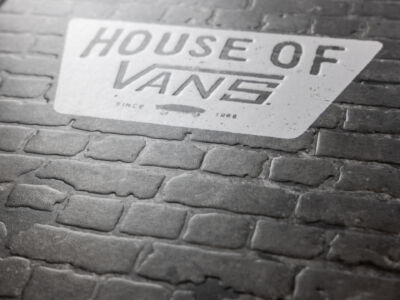 The word wine on a brick wall.
(HOUSEOF VAVG SINCe 1986,no person, street, pavement, outdoors, road, old, retro, dirty, asphalt, monochromatic, traffic, urban, stone, business, worn, rough, dark, monochrome, rain, ground)