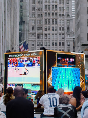 The crowd watching the game.
(EVERY MOMENT.GVERY MEDAL PULISIC,street, city, people, Broadway, business, festival, crowd, group, drag race, shopping, police, many, music, flag signal, commerce, road, competition, battle, urban, rally)